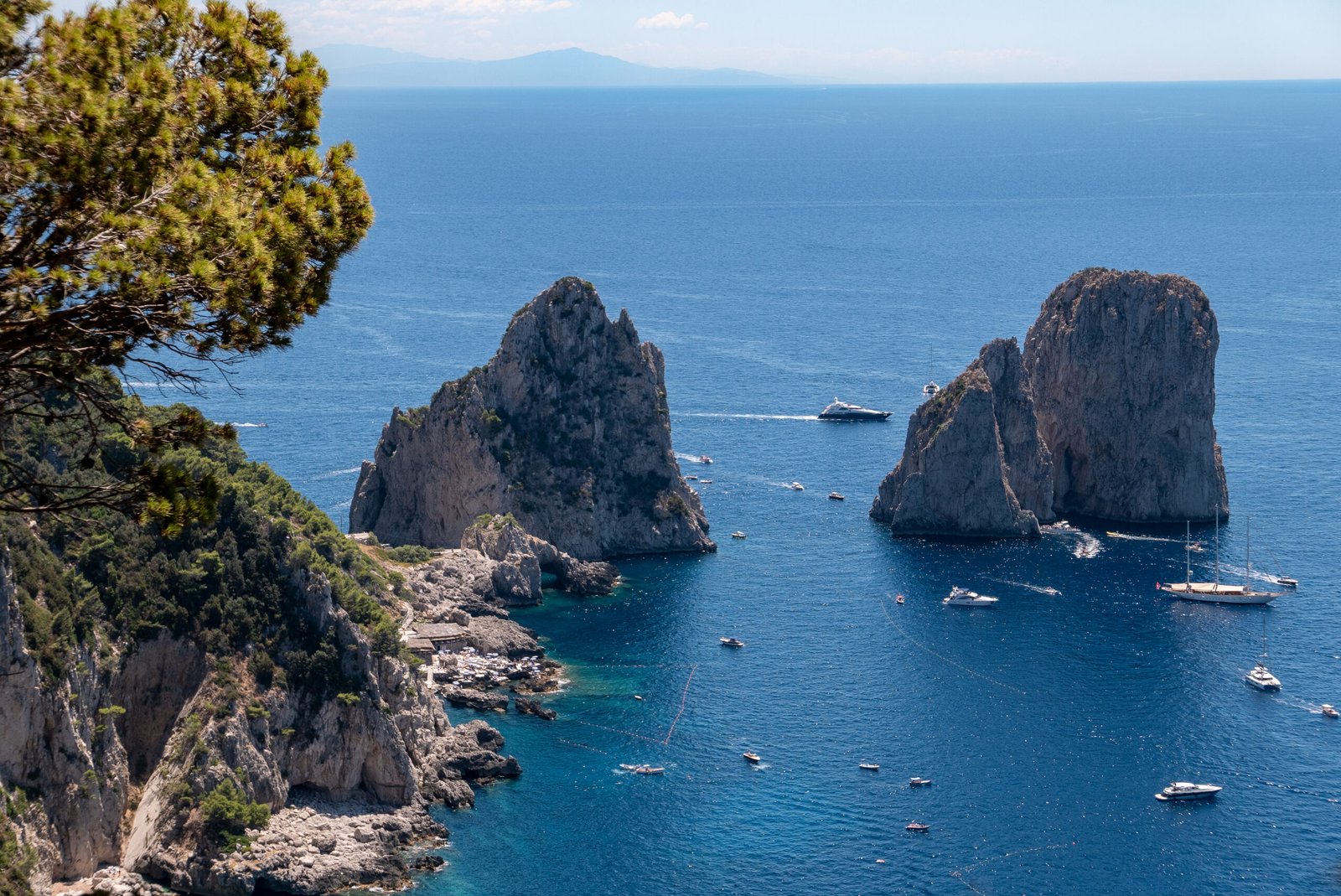 Faraglioni rock formations rising from the sea off the coast of Capri, Italy