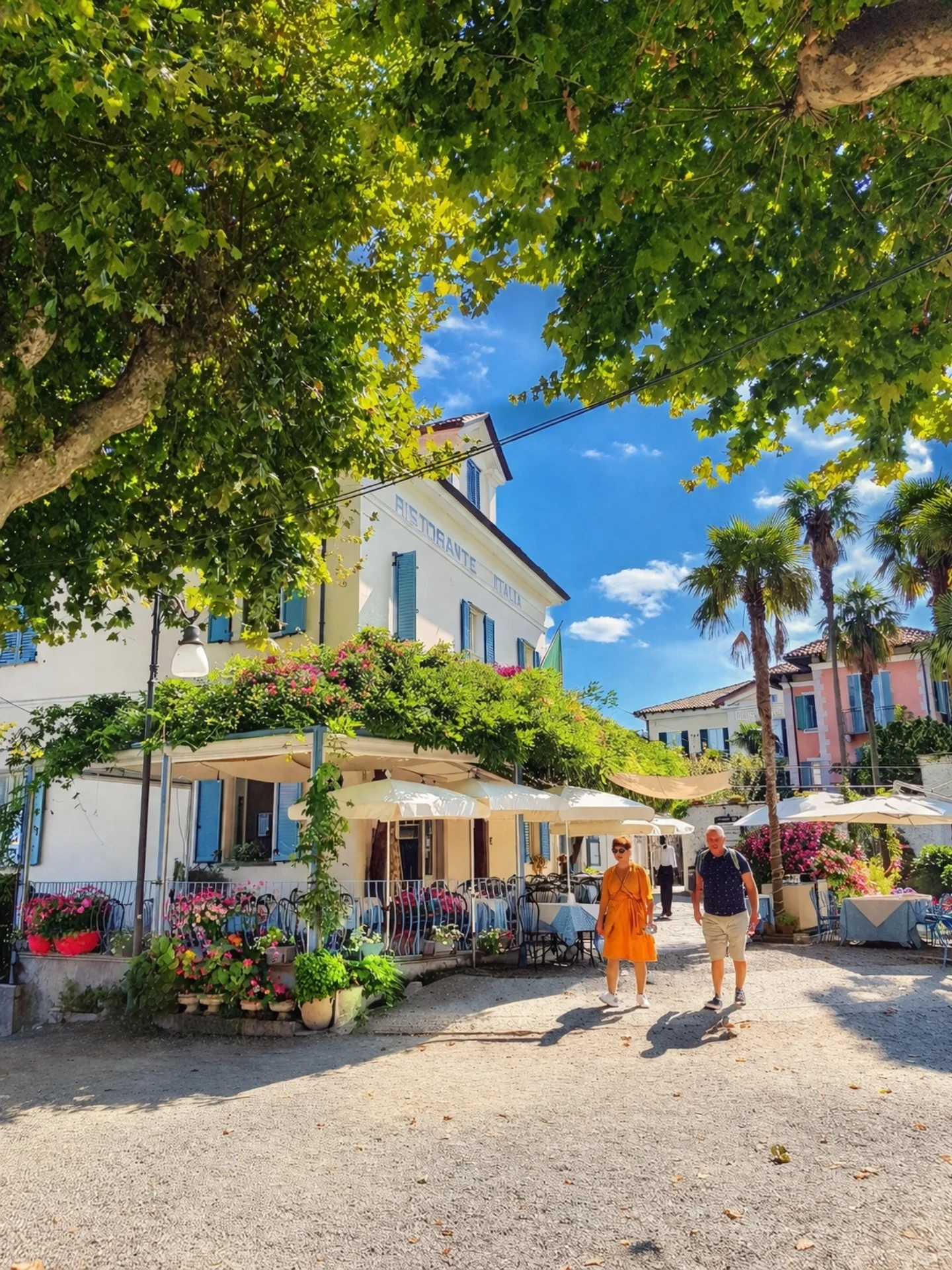 Village lane on Isola Bella with cafes under a plane tree