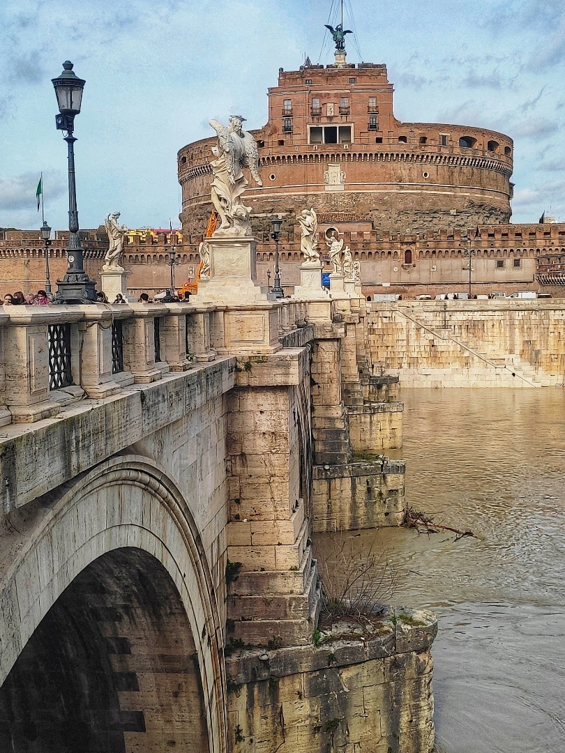 Ponte Sant'Angelo bridge lined with angel statues leading to Castel Sant'Angelo over the Tiber River, Rome